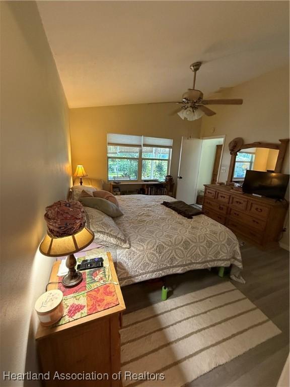 100 Daisy Ln, Lake Placid, FL 33852 - bedroom with lofted ceiling, wood finished floors, and a ceiling fan