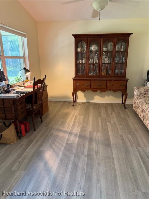 100 Daisy Ln, Lake Placid, FL 33852 - dining space with light wood-type flooring, baseboards, and a desk