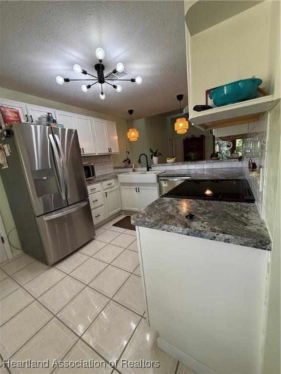 100 Daisy Ln, Lake Placid, FL 33852 - kitchen featuring appliances with stainless steel finishes, a sink, white cabinetry, a textured ceiling, and light tile patterned flooring