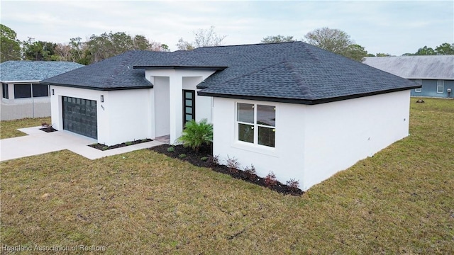 view of front of home with a front lawn and a garage