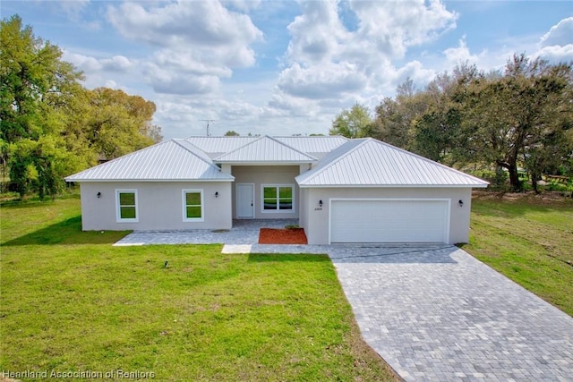 view of front of home featuring a garage and a front lawn