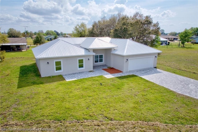 view of front of property with a front lawn and a garage