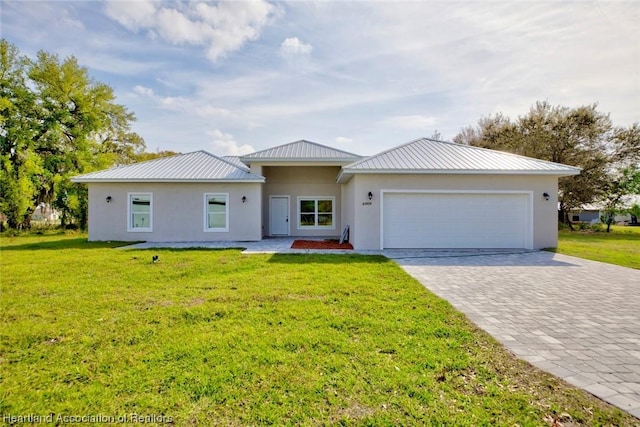 ranch-style house with a garage and a front lawn