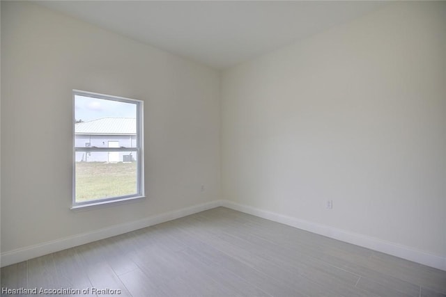 spare room featuring light hardwood / wood-style flooring