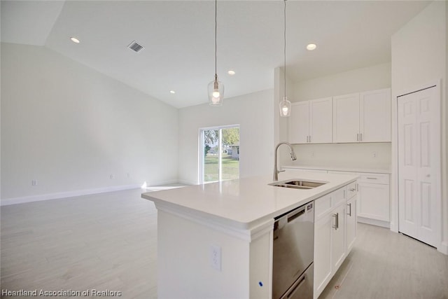 kitchen featuring stainless steel dishwasher, a kitchen island with sink, sink, white cabinetry, and hanging light fixtures