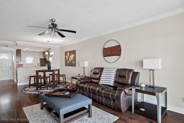 living room featuring ceiling fan with notable chandelier, dark hardwood / wood-style flooring, and crown molding