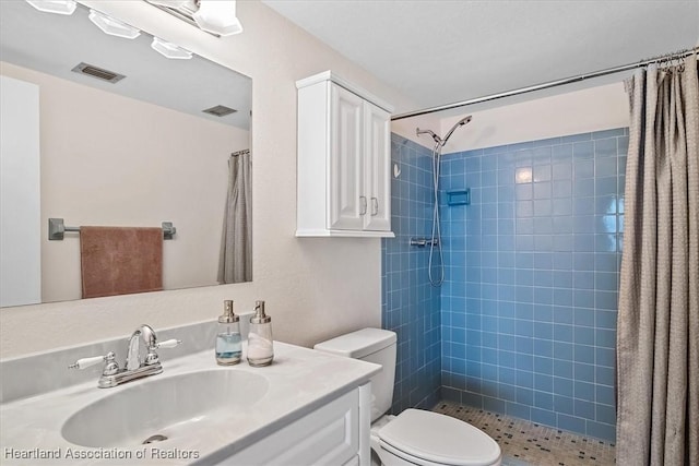 bathroom with curtained shower, vanity, and toilet