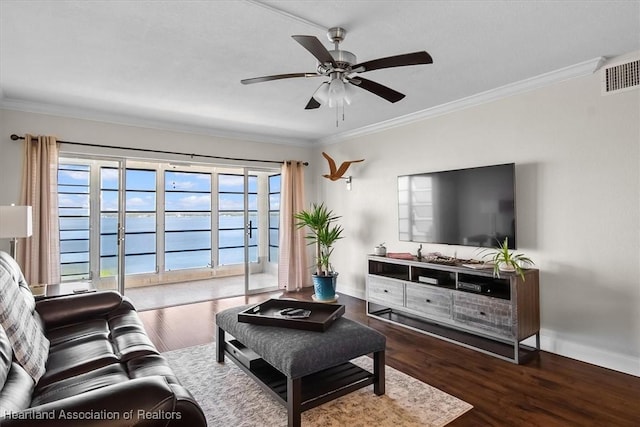 living room featuring ceiling fan, a healthy amount of sunlight, dark hardwood / wood-style flooring, and ornamental molding