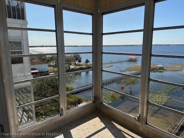 sunroom with a water view and a wealth of natural light