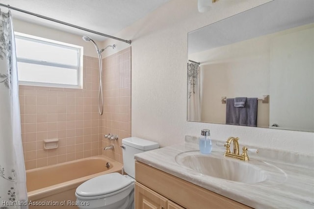 full bathroom featuring shower / tub combo with curtain, vanity, and toilet