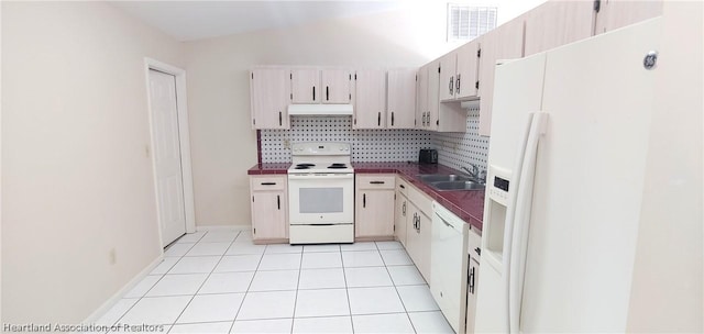 kitchen featuring backsplash, sink, light tile patterned floors, and white appliances