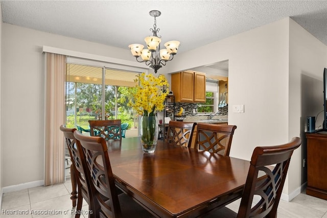 1536 Meadowbrook St, Lake Placid, FL 33852 - dining space with a chandelier, light tile patterned floors, baseboards, and a textured ceiling
