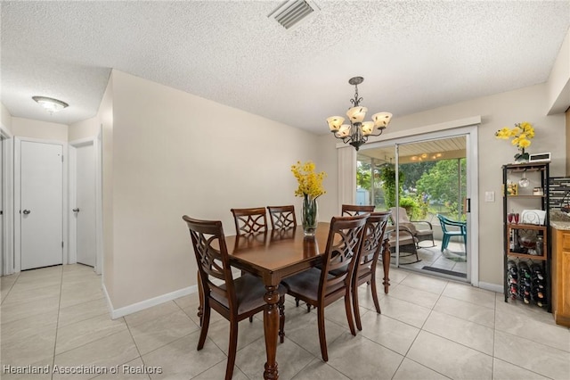 1536 Meadowbrook St, Lake Placid, FL 33852 - dining room featuring a textured ceiling, a chandelier, light tile patterned flooring, and baseboards