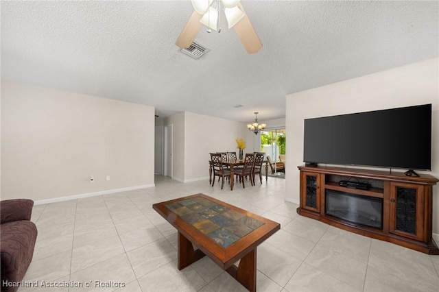1536 Meadowbrook St, Lake Placid, FL 33852 - living room featuring a chandelier, a textured ceiling, ceiling fan, light tile patterned floors, and baseboards