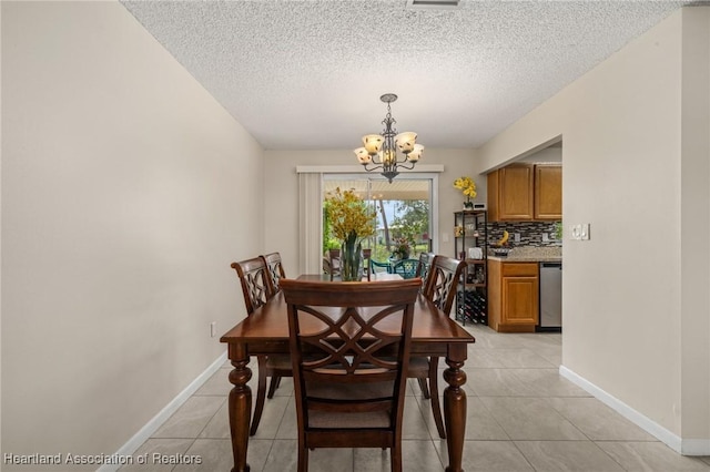 1536 Meadowbrook St, Lake Placid, FL 33852 - dining room with a chandelier, light tile patterned floors, baseboards, and a textured ceiling