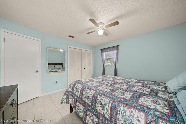 1536 Meadowbrook St, Lake Placid, FL 33852 - bedroom with a closet, light tile patterned floors, ceiling fan, a textured ceiling, and baseboards