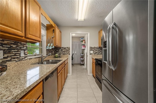 1536 Meadowbrook St, Lake Placid, FL 33852 - kitchen with appliances with stainless steel finishes, a sink, decorative backsplash, light tile patterned floors, and a textured ceiling