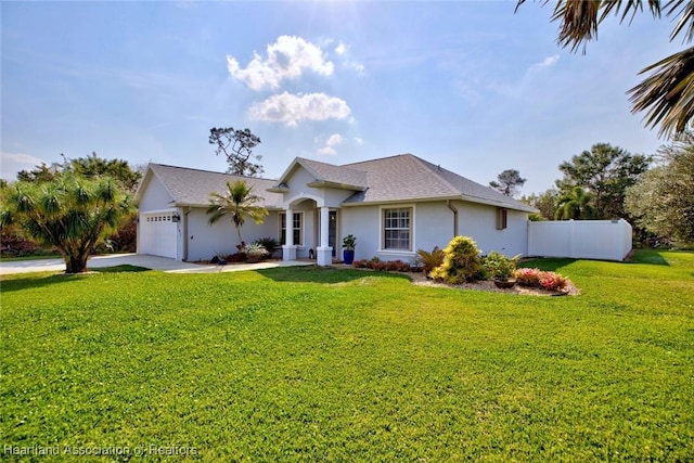 view of front of home with a front lawn, driveway, and an attached garage