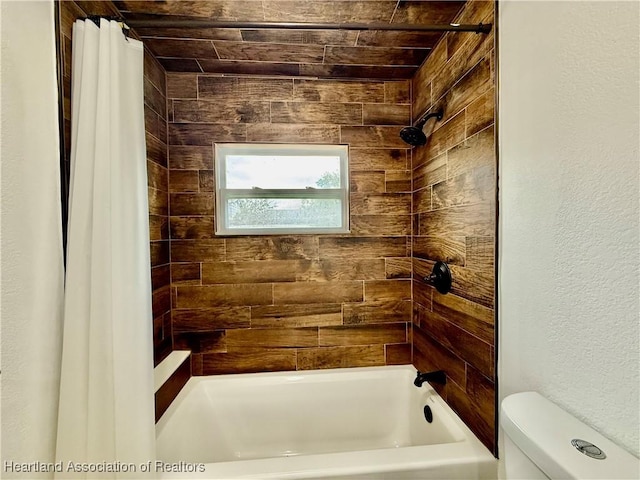 bathroom with toilet and shower / bath combo with shower curtain