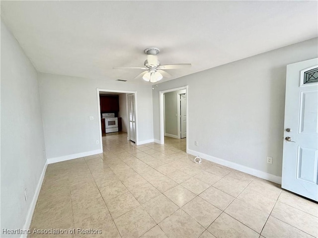 spare room with visible vents, baseboards, a ceiling fan, and light tile patterned flooring