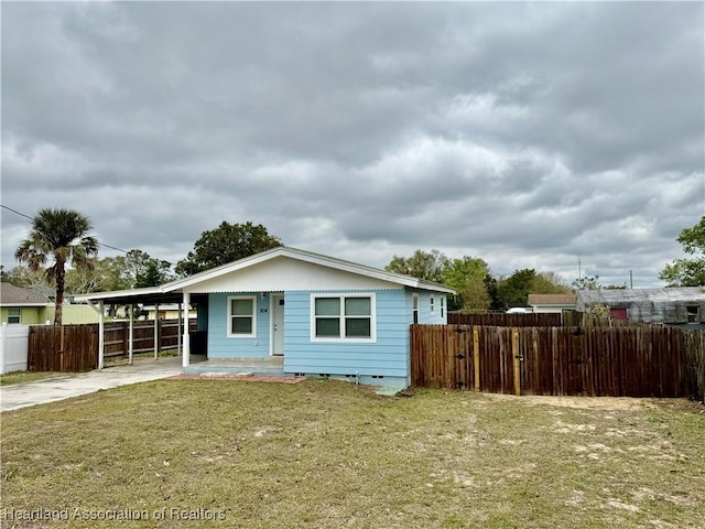 view of front facade featuring concrete driveway, a front yard, crawl space, fence, and an attached carport