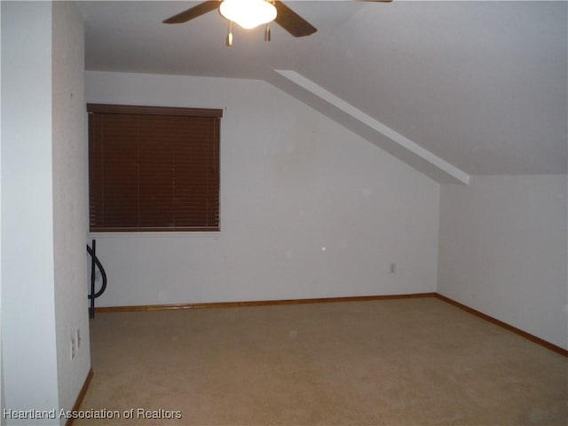 additional living space with light carpet, ceiling fan, and lofted ceiling