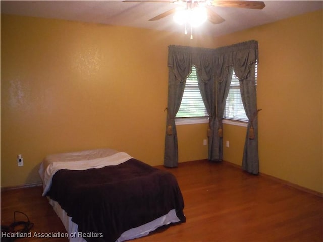 bedroom featuring wood-type flooring and ceiling fan