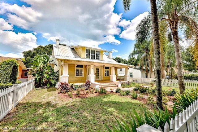2220 Lakeview Dr, Sebring, FL 33870 - view of front of house featuring a fenced backyard, a porch, metal roof, and a front yard