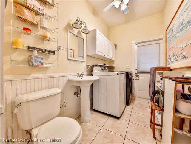 2220 Lakeview Dr, Sebring, FL 33870 - bathroom with a ceiling fan, wainscoting, toilet, tile patterned floors, and independent washer and dryer