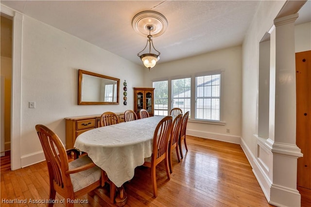 2220 Lakeview Dr, Sebring, FL 33870 - dining space featuring baseboards, decorative columns, and light wood finished floors