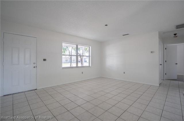 spare room with visible vents and baseboards