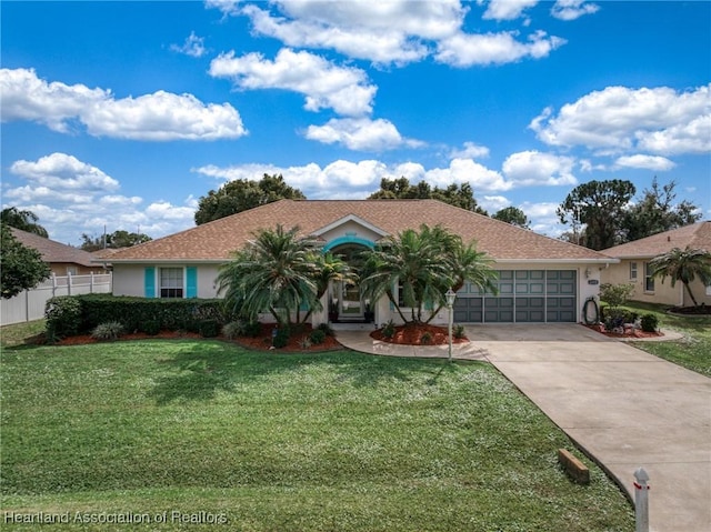 ranch-style home featuring a garage and a front lawn