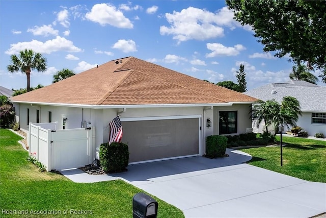 ranch-style home featuring a garage and a front lawn