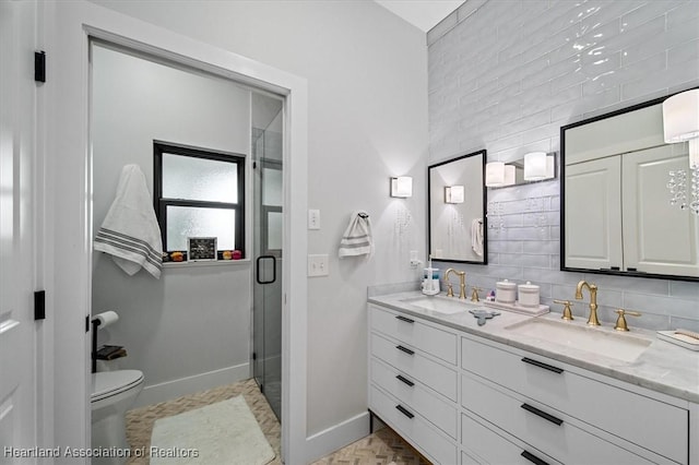 bathroom featuring backsplash, toilet, vanity, and walk in shower