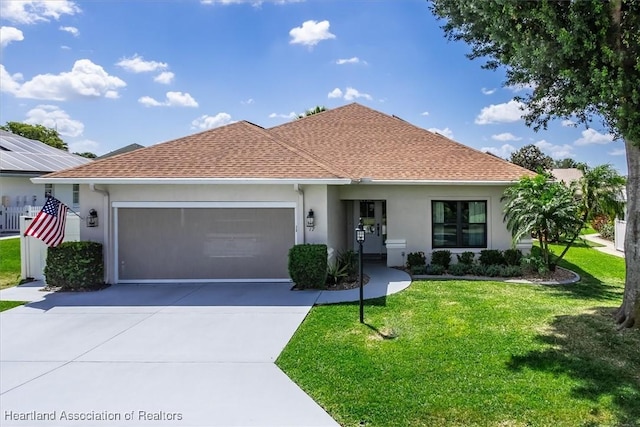 view of front of property featuring a front yard and a garage