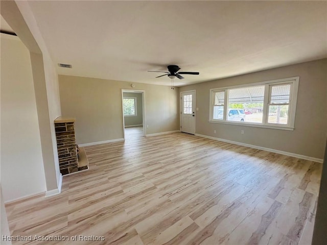 602 Wilhite St, Avon Park, FL 33825 - unfurnished living room with baseboards, visible vents, light wood-style floors, and ceiling fan