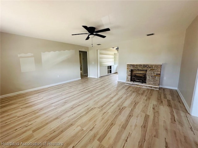 602 Wilhite St, Avon Park, FL 33825 - unfurnished living room with visible vents, light wood-type flooring, baseboards, a fireplace, and ceiling fan