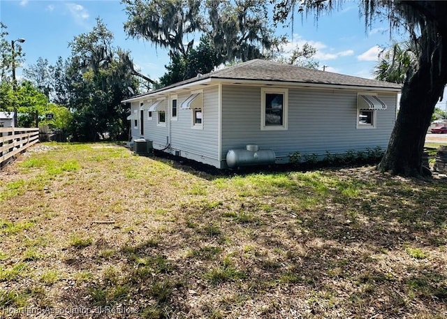 602 Wilhite St, Avon Park, FL 33825 - view of side of home featuring a lawn, central AC unit, and fence