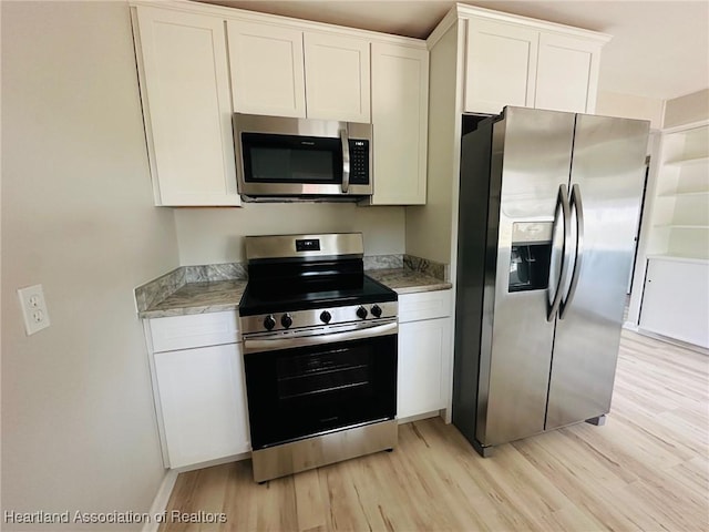 602 Wilhite St, Avon Park, FL 33825 - kitchen featuring light wood-style flooring, baseboards, white cabinetry, light countertops, and appliances with stainless steel finishes