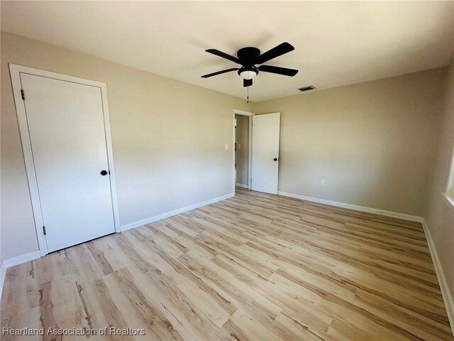 602 Wilhite St, Avon Park, FL 33825 - unfurnished bedroom featuring baseboards, wood finished floors, visible vents, and a ceiling fan
