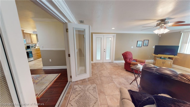 living room featuring crown molding, french doors, and ceiling fan