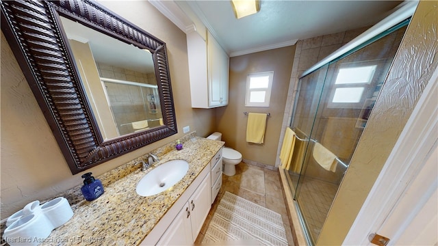 bathroom featuring crown molding, a shower with door, vanity, and toilet