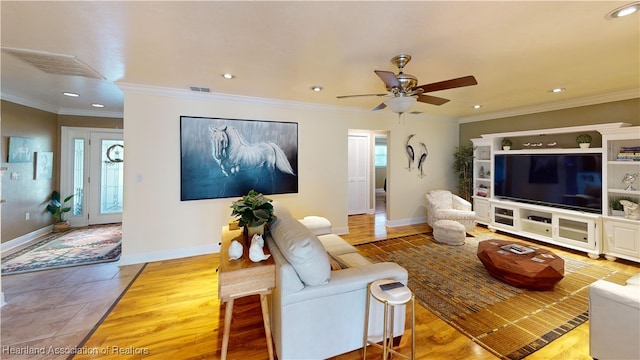 tiled living room featuring ceiling fan and ornamental molding