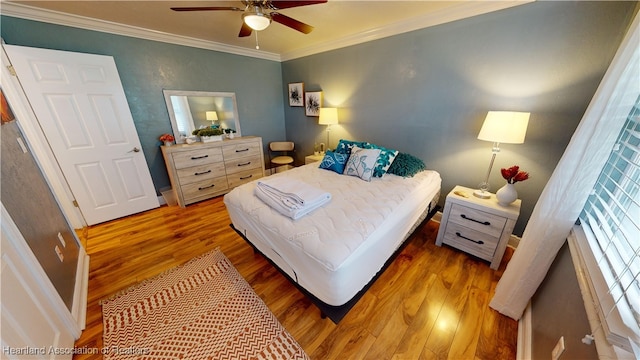 bedroom featuring hardwood / wood-style floors, ceiling fan, and ornamental molding