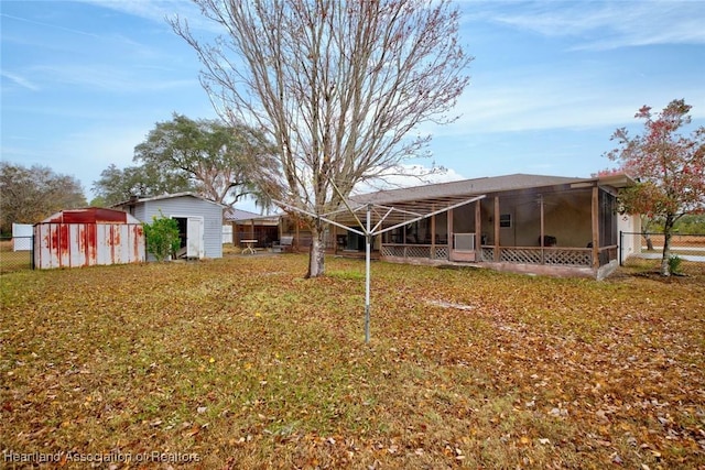 view of yard with a storage unit and a sunroom