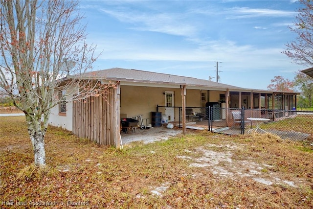 rear view of house with a sunroom