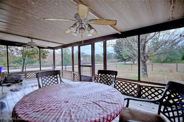 sunroom / solarium featuring wood ceiling, ceiling fan, and a healthy amount of sunlight