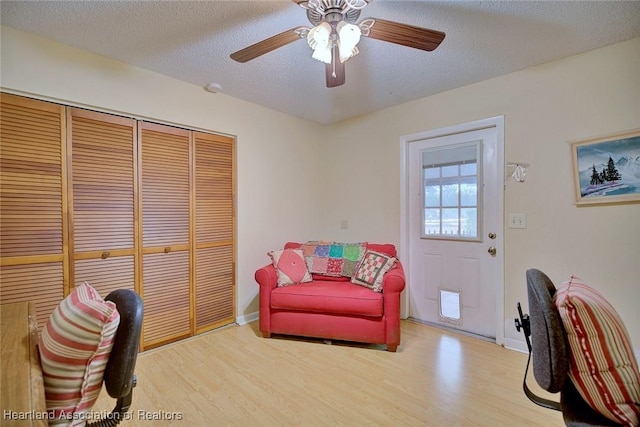 home office featuring ceiling fan, a textured ceiling, and light hardwood / wood-style floors