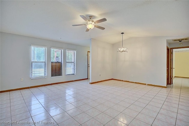 empty room featuring baseboards, lofted ceiling, light tile patterned floors, and ceiling fan with notable chandelier