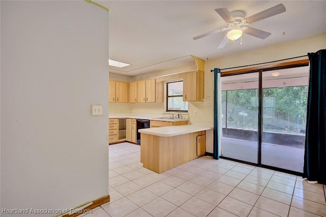 kitchen featuring a peninsula, light brown cabinets, ceiling fan, black dishwasher, and light countertops